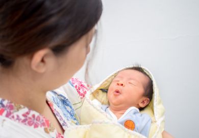 Baby carried by mother illustrating how work-life balance influences gender disparity in science