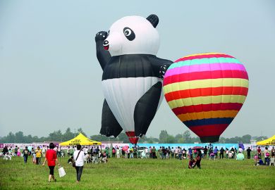 A panda-shaped hot-air balloon is displayed during the Zhengzhou Airshow to illustrate China’s tuition fee hikes ‘foreshadow’ marketised  HE system