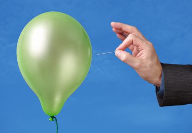 Hand bursting a balloon