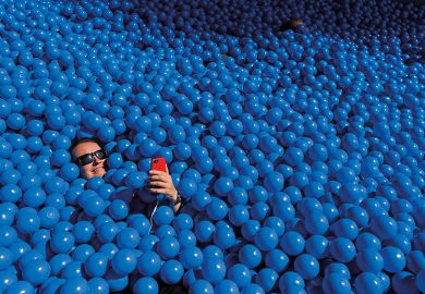 Person taking a selfie in a ball pit