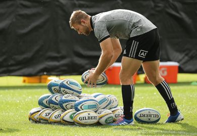 rugby player with pile of balls