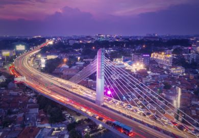 Aerial view of glowing Pasupati overpass at evening in Bandung city  Aerial view of glowing Pasupati overpass at evening in Bandung city