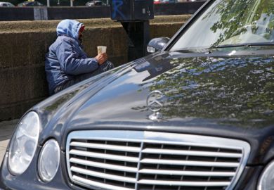 Beggar next to Mercedes