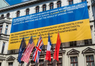 Berlin, Germany - May 28, 2017 Flags of Ukraine, NATO, USA, UK, France, former USSR on the wall of the Haus am Checkpoint Charlie museum as solidarity with Ukraine in Berlin, Germany.