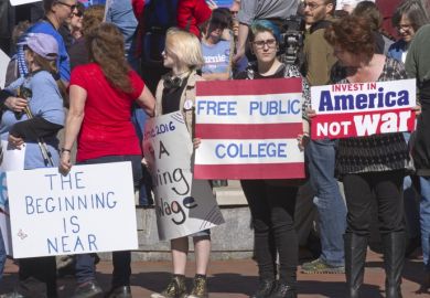 Bernie Sanders supporters with a free college sign Bernie Sanders supporters with a free college sign