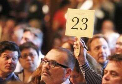 Bidder raising paddle, Napa Valley Barrel Auction