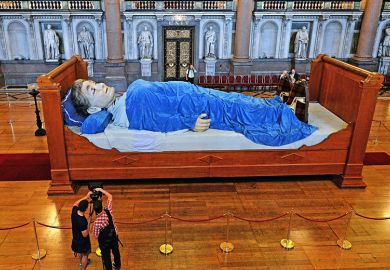 Sculpture of giant in bed