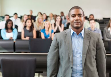 A black academic in a lecture hall A black academic in a lecture hall