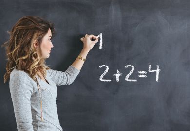 woman writes on blackboard woman writes on blackboard