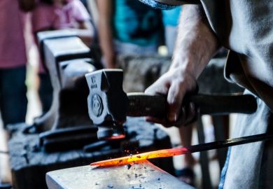 Blacksmith hammering a sword