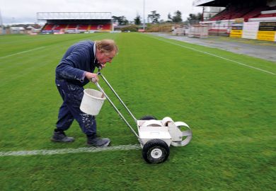 Man painting lines on a pitch Man painting lines on a pitch