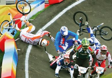 Group of BMX riders fall during race