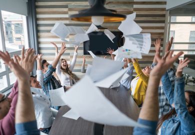 Boardroom of people celebrating and throwing papers in air Boardroom of people celebrating and throwing papers in air