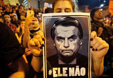 Woman holds poster of Jair Bolsonaro