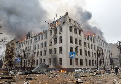 Firefighters work to contain a fire at the Economy Department building of Karazin Kharkiv National University, allegedly hit during recent shelling by Russia, on March 2, 2022