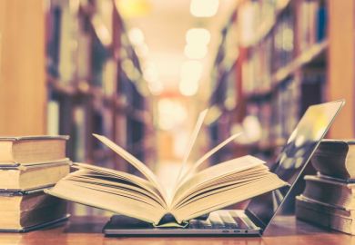 Book and laptop in library