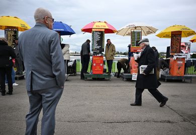 Racegoers walk past bookmakers' betting stands on the final day of the Grand National Festival horse race meeting, illustrating the low success rates for some UK research council grant schemes. Racegoers walk past bookmakers' betting stands on the final day of the Grand National Festival horse race meeting, illustrating the low success rates for some UK research council grant schemes.