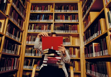 Person reading books in library Person reading books in library