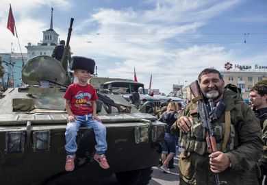 Boy sitting on armoured personnel carrier, Luhansk, Ukraine, 2014