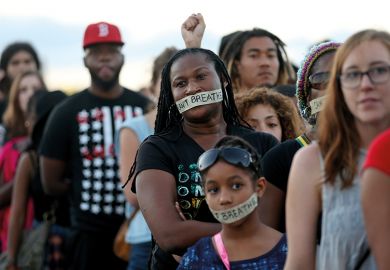 Demonstrators stand with tape reading: “ I can’t breathe” to protest police abuse Demonstrators stand with tape reading: “ I can’t breathe” to protest police abuse on December 7, 2014 in Miami, Florida.