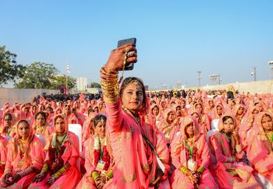 A Muslim bride takes a selfie with her mobile phone as she participates in an ‘All Religion Mass Wedding’ ceremony at Sabarmati Riverfront in Ahmedabad, India on 8 February 2020.