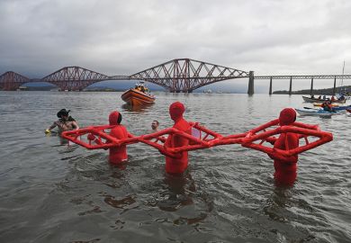 People in water pretending to be a bridge