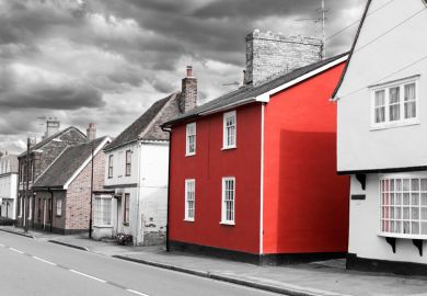 Bright red house on washed-out British street