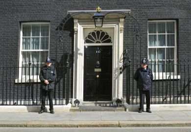 British police officers guarding 10 Downing Street entrance, London