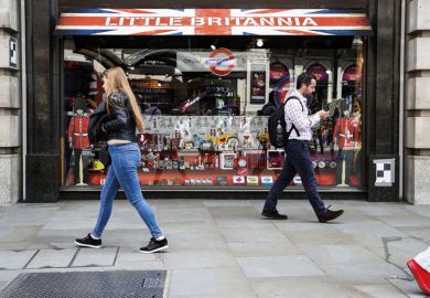 People walking past Little Britannia shop, London People walking past Little Britannia shop, London