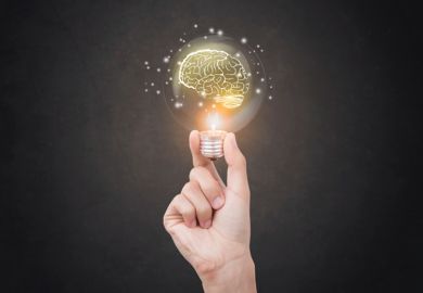 Hand holding light bulb