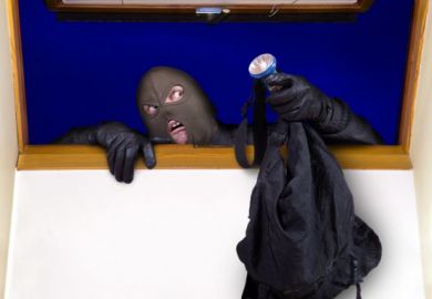 A masked person climbing through a window A masked person climbing through a window
