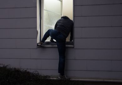 Burglar climbing in a window Burglar climbing in a window