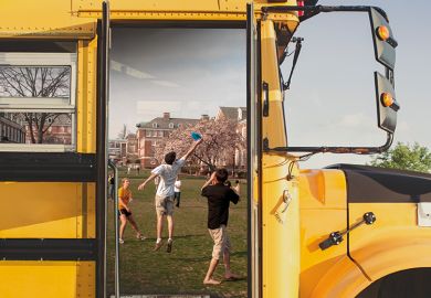 University students framed by school bus door