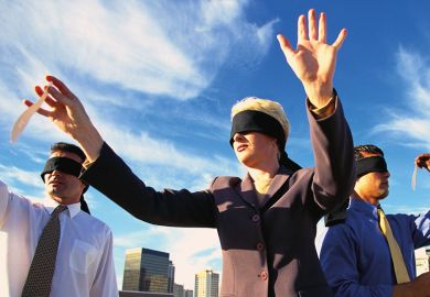 Business people on roof playing pin the tail on the donkey Business people on roof playing pin the tail on the donkey