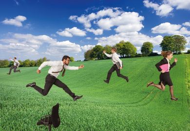 Business people running through field