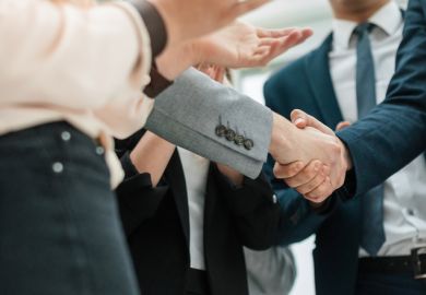 Business partners shaking hands in the office