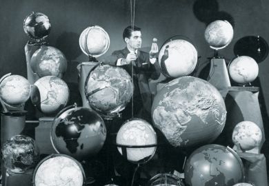 Businessman surrounded by globes of the world