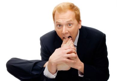 Businessman with foot in mouth