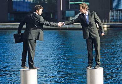 Businessmen shaking hands from pedestals in river Businessmen shaking hands from pedestals in river