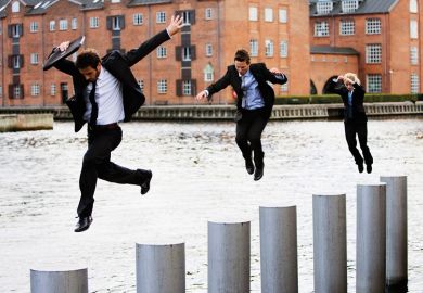 Businesspeople jumping across pillars in city river Businesspeople jumping across pillars in city river