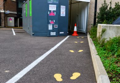 Cambridge UK, England ,24-11-2020, Painted footprints on asphalt outside University covid test station. The University offers swab tests to College and University staff and students displaying symptoms