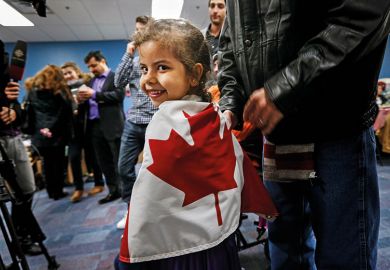 Syrian child wrapped in Canadian flag