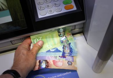 Someone takes Canadian money from an ATM Someone takes Canadian money from an ATM