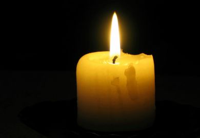 Candle burning in blacked-out room Candle burning in blacked-out room