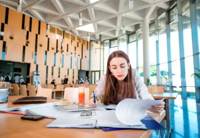 A woman studying in a university or college canteen