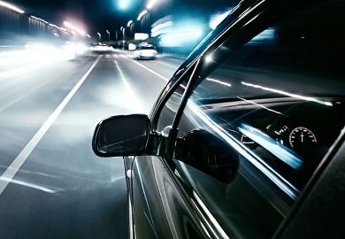 Car driving quickly into European motorway fast lane