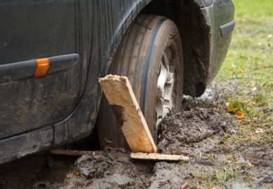 A car wheel stuck in a rut A car wheel stuck in a rut