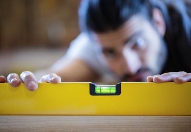 Carpenter measuring with spirit level Carpenter measuring with spirit level