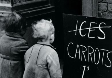 Small children looking at 'Carrots instead of ice lollies' sign
