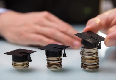 Hand Placing Graduation Hat Over Stacked Coins In A Row